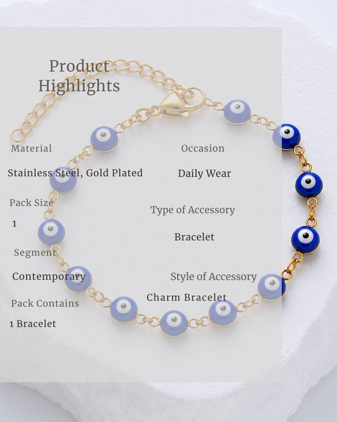 Gold bracelet with blue evil eye beads on a white background