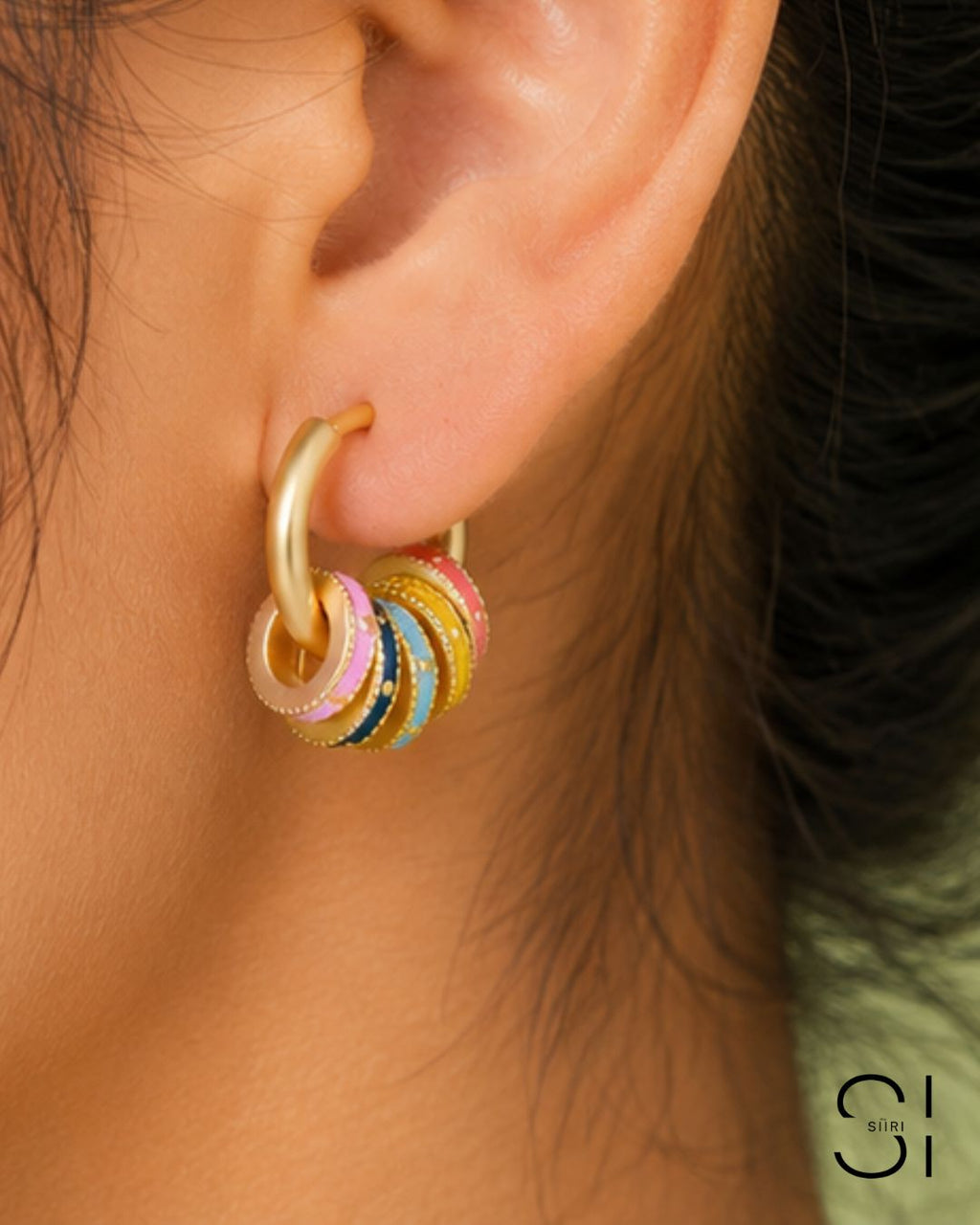 Model wearing Candy Pop Charm Hoops featuring multi-color charm accents