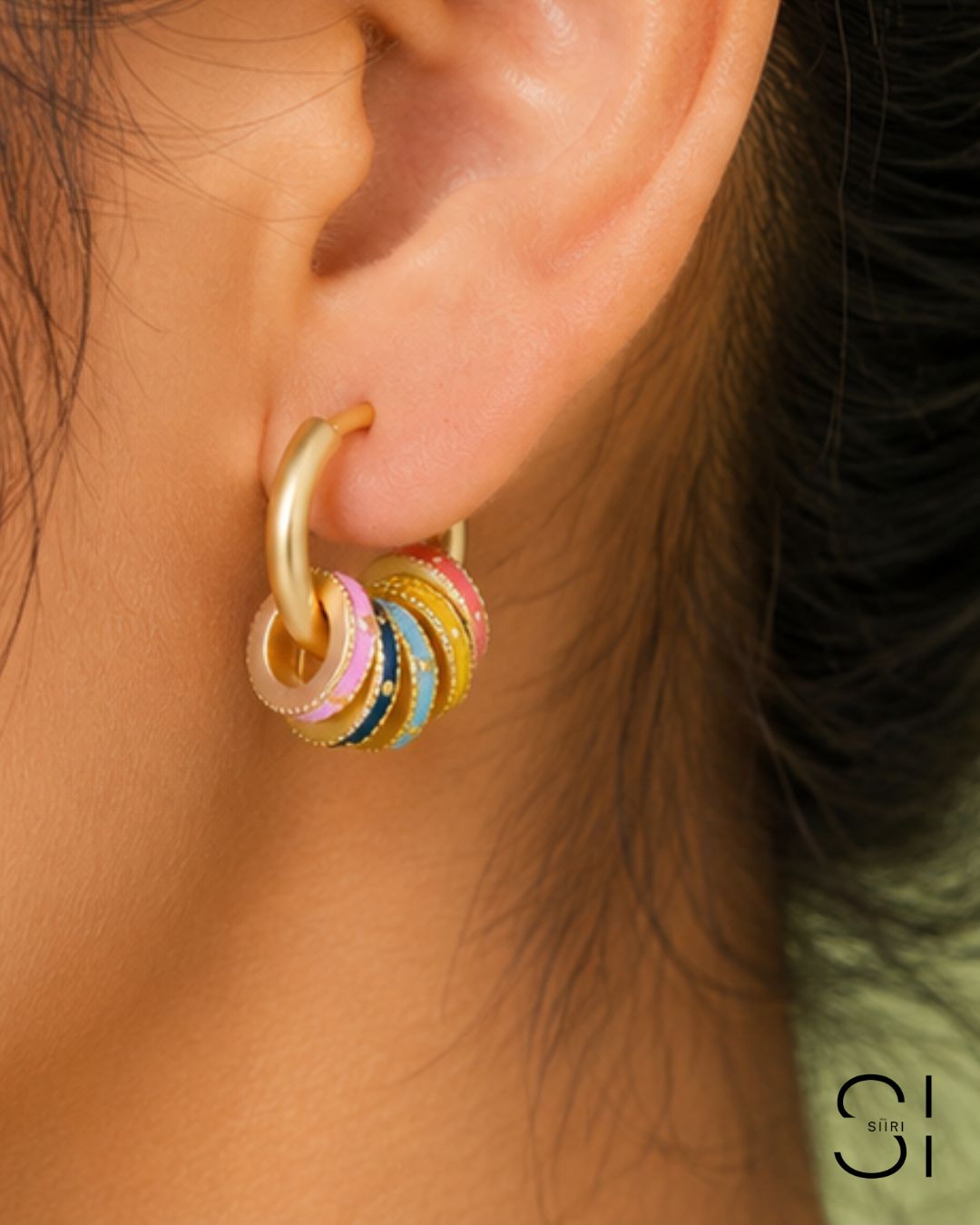 Model wearing Candy Pop Charm Hoops featuring multi-color charm accents