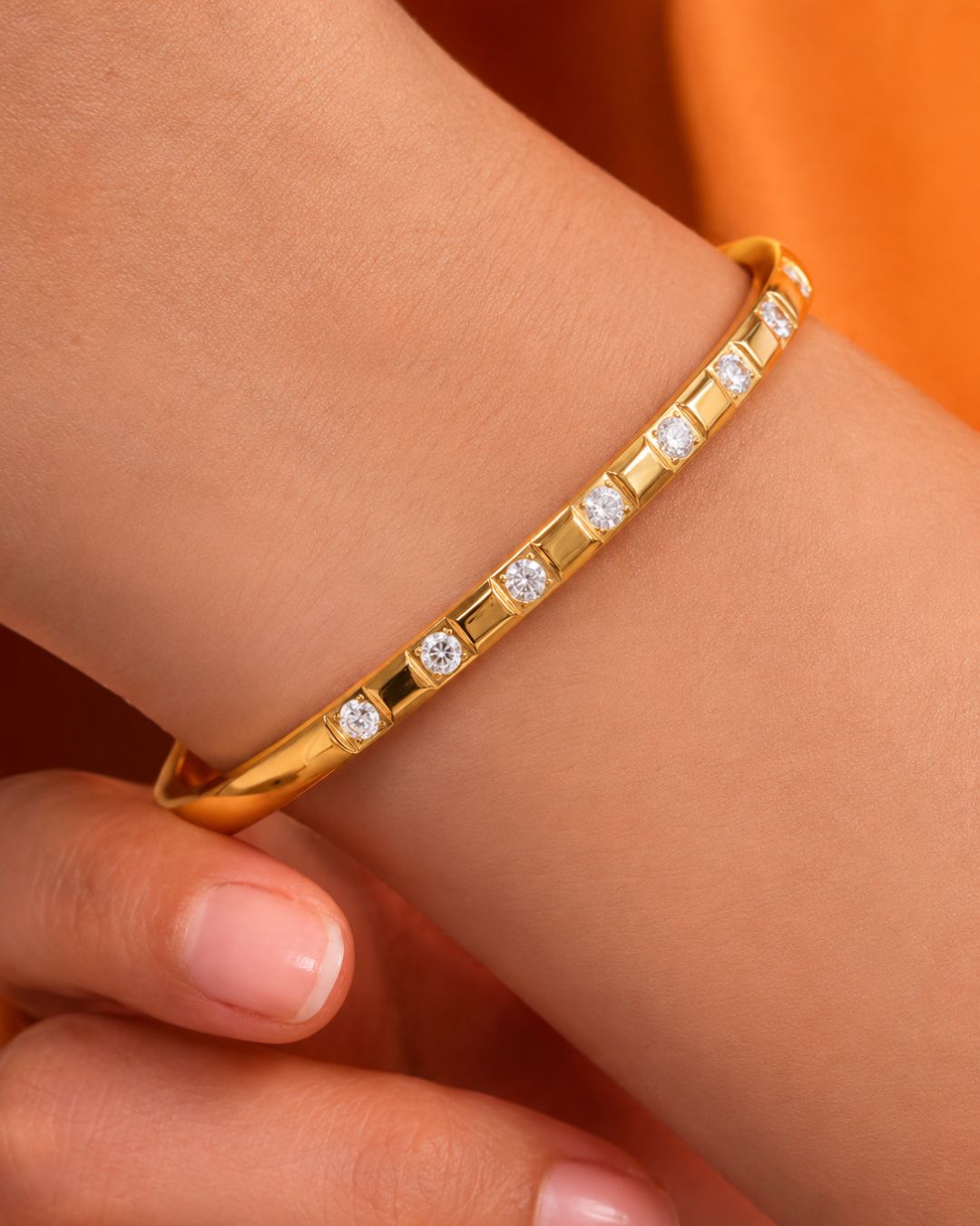 Gold bracelet with diamonds on a wrist 
