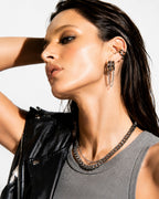 Dual Tone Chain Drop lightweight earrings with modern statement chain design Woman wearing a black leather vest and gray top with jewelry on a white background