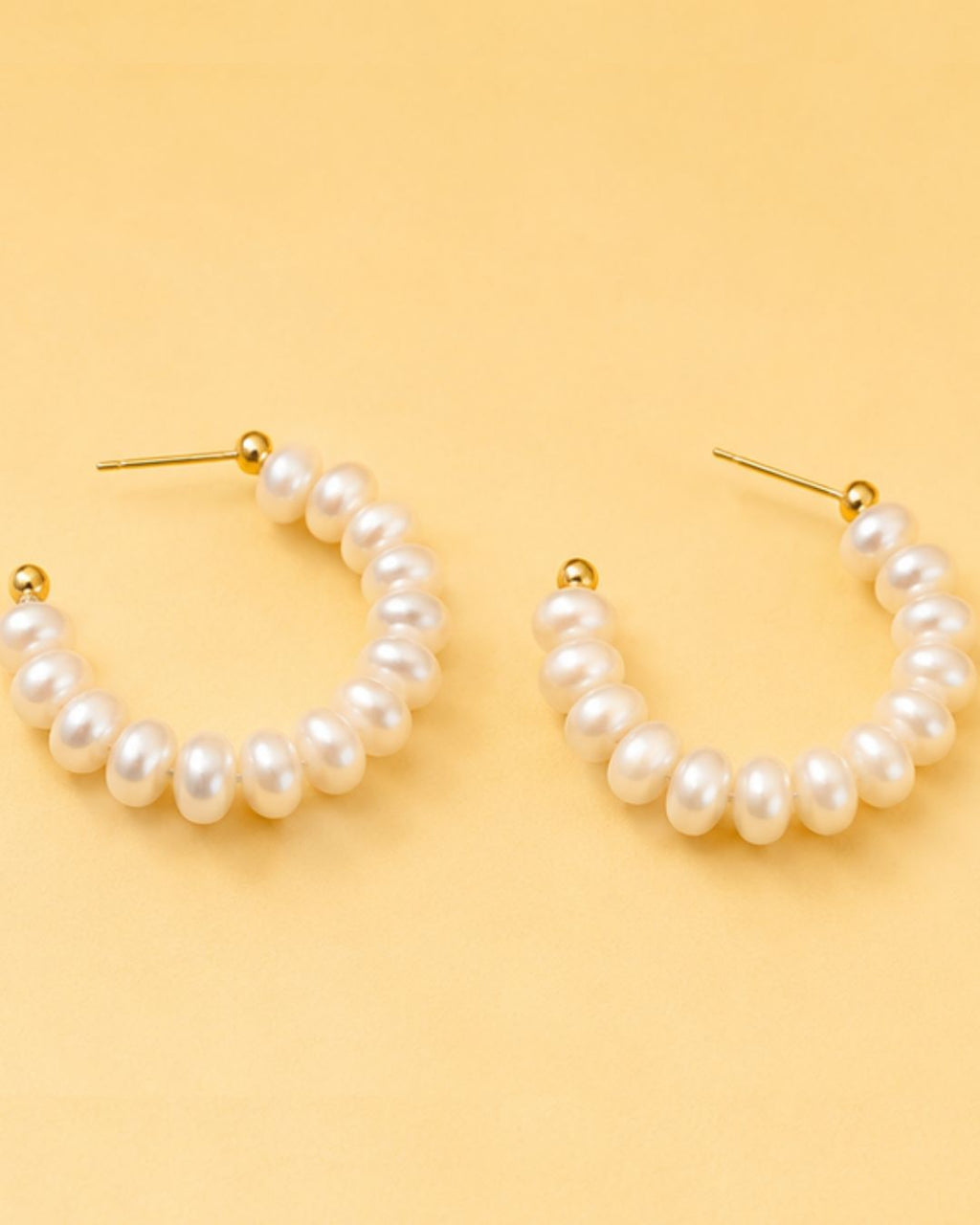 Detailed view of Pearl Loop Hoops with statement pearl arrangement and elegant hoop silhouette