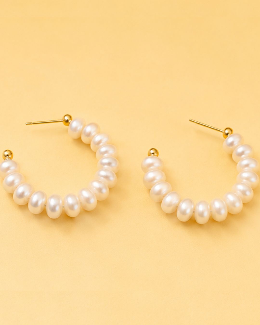 Detailed view of Pearl Loop Hoops with statement pearl arrangement and elegant hoop silhouette
