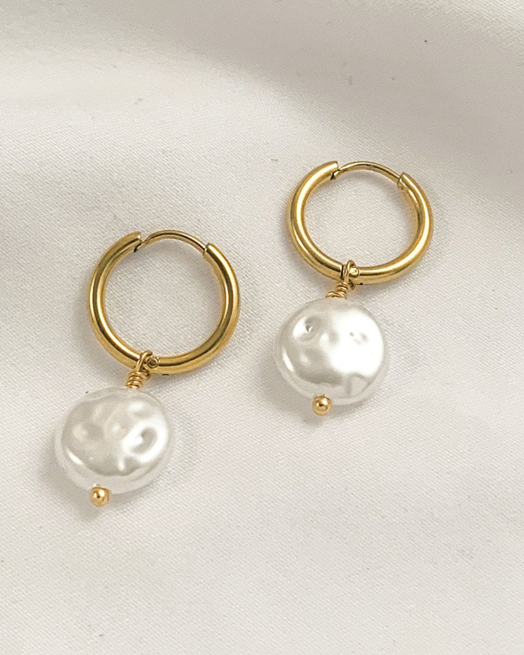 Gold hoop earrings with white pearls 