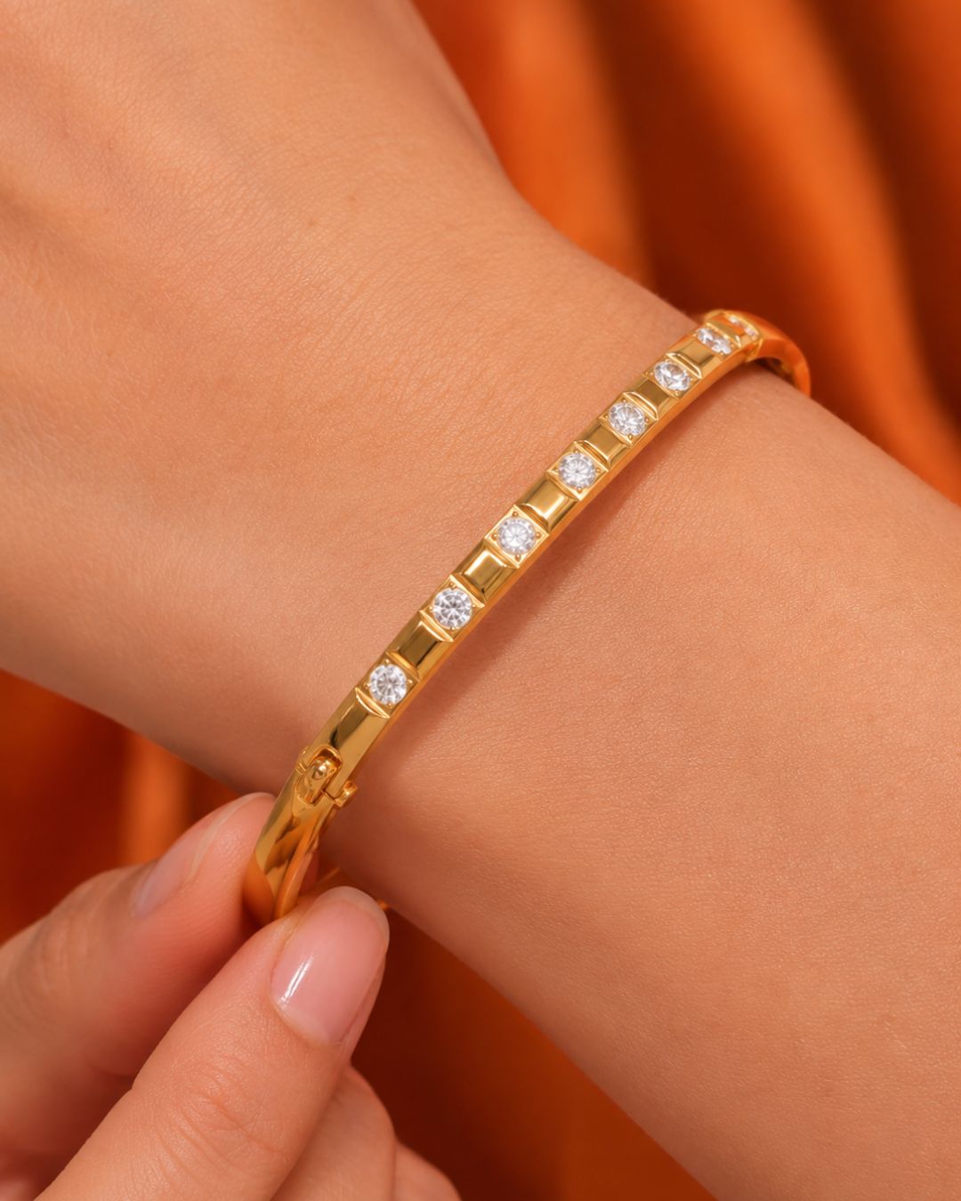 Gold bracelet with diamonds on a wrist 