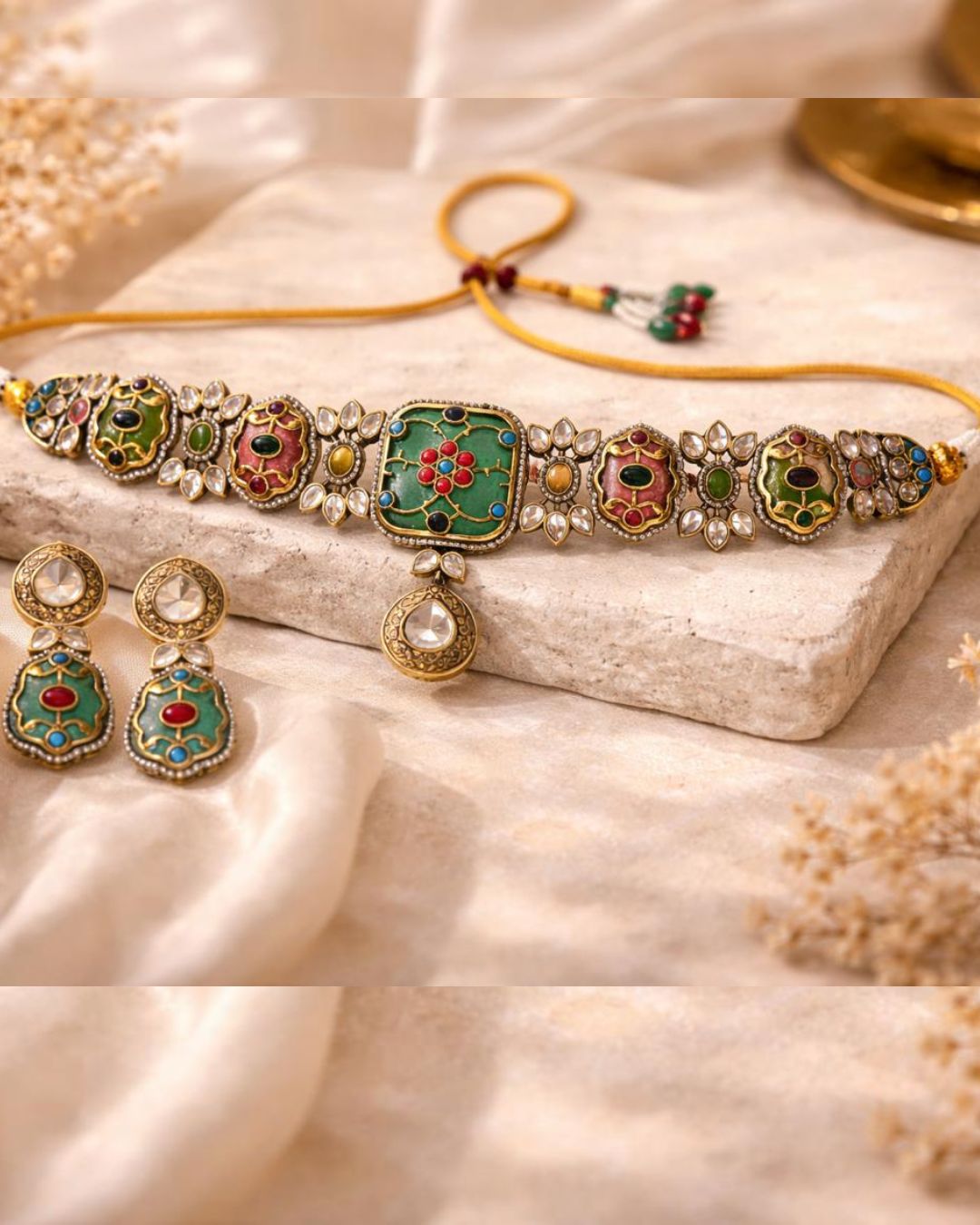 Close-up of Rang Mahal choker featuring pink and green Kundan stones with intricate gold plated detailing