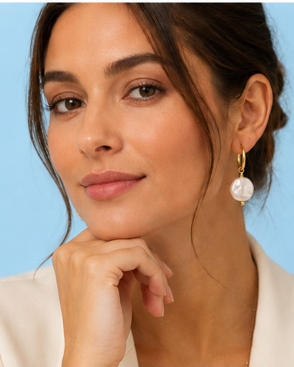 Close-up of Pearl Drop Huggies showcasing luminous pearl charm and gold plated hoop
