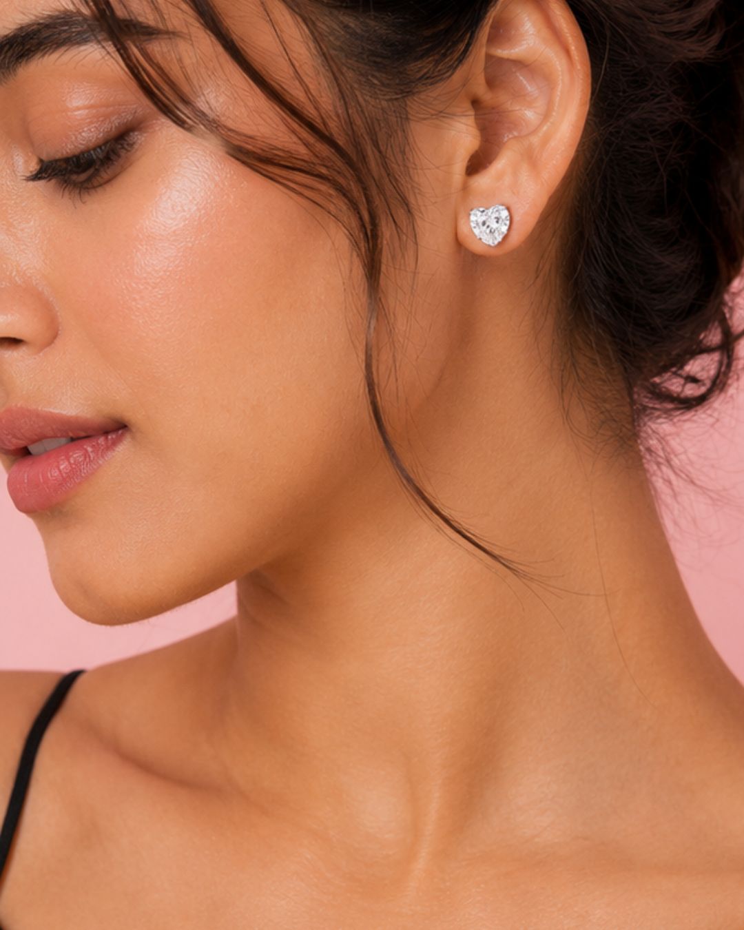 Model wearing 925 sterling silver heart-shaped cubic zirconia stud earrings