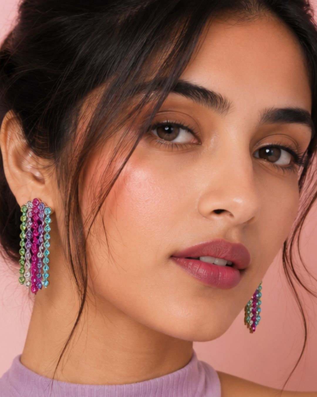 Close-up of a woman wearing colorful earrings for a party wear look statement styling