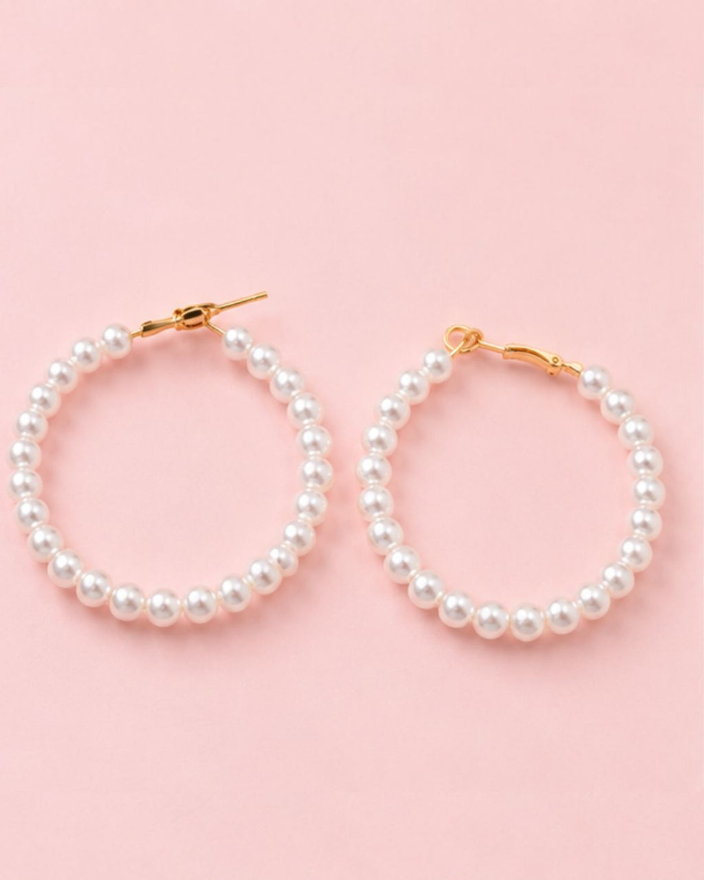 Close-up of Pearl Muse Hoops featuring lustrous pearl beads and gold plated accents