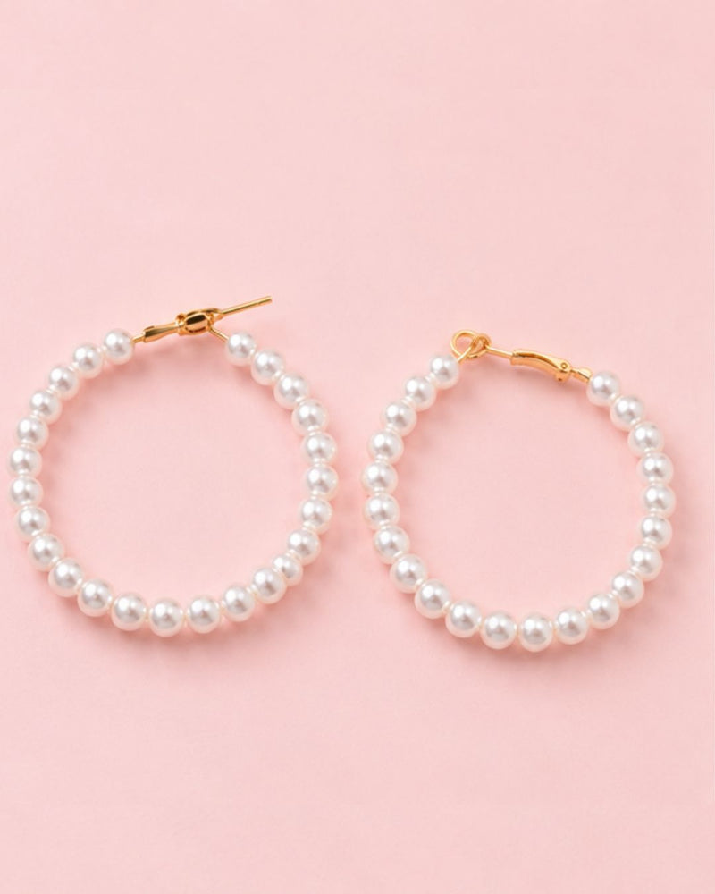 Close-up of Pearl Muse Hoops featuring lustrous pearl beads and gold plated accents