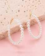 Detailed view of Pearl Muse Hoops with elongated pearl hoop silhouette and elegant craftsmanship