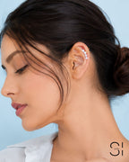 Model wearing a pearl ear cuff with gold plated accents and faux pearl embellishments anti tarnish no piercing stylish peal earrings